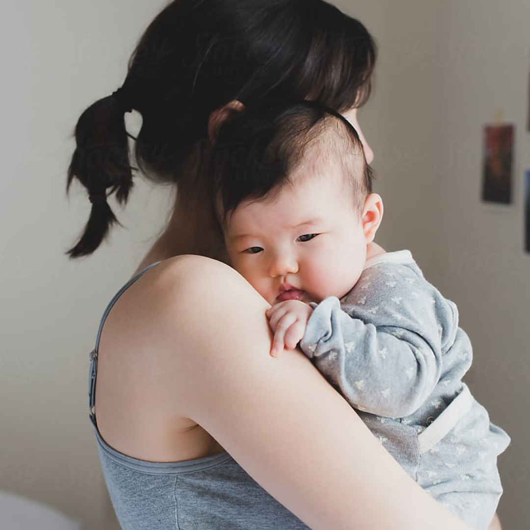Mother hugs newborn baby