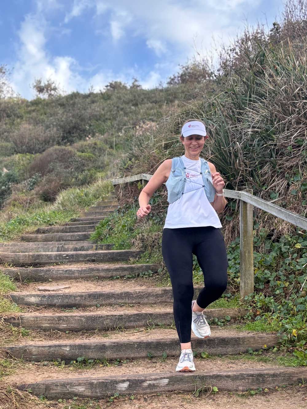 Trish runs down path wearing Gigdet singlet and visor Trish runs down path wearing Gigdet singlet and visor
